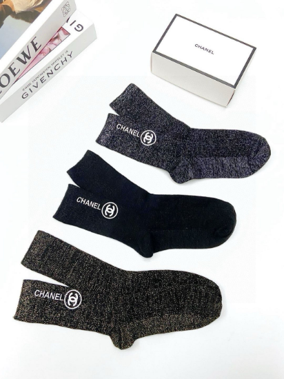 Picture of Chanel classic letter logo socks. These are mid-calf socks made of a blend of gold and silver threads and pure cotton.